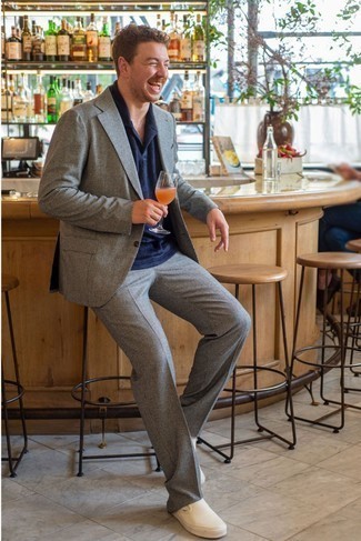 White Slip-on Sneakers Outfits For Men: If you don't take fashion lightly, go for classy style in a grey check suit and a navy polo. Why not introduce a pair of white slip-on sneakers to the equation for a sense of stylish nonchalance?