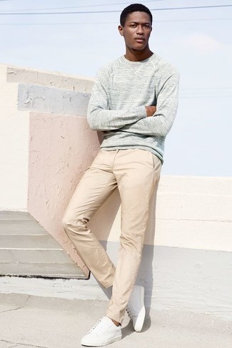 Beige Chinos Spring Outfits: Pairing a grey crew-neck sweater with beige chinos is a good idea for a relaxed casual ensemble. Complete your ensemble with a pair of white leather low top sneakers to effortlessly bump up the style factor of your ensemble. Keep this outfit in your front hall wardrobe when spring comes, and we promise you'll save a lot of time getting ready on more than one morning.