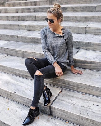 Grey Crew-neck Sweater Outfits For Women: Wear a grey crew-neck sweater and black ripped skinny jeans if you're on the lookout for a look idea for when you want to look casual and cool. Dial up the classiness of this outfit a bit with a pair of black studded leather ankle boots.