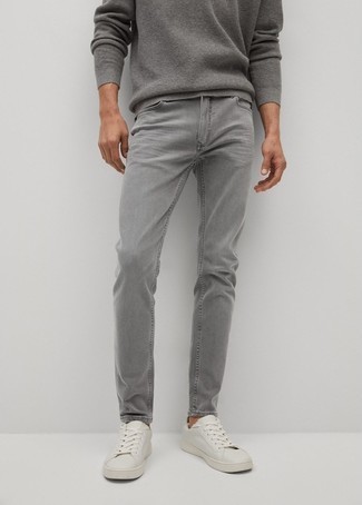 Grey Jeans Outfits For Men: Fashionable and comfortable, this casual combo of a grey crew-neck sweater and grey jeans offers wonderful styling opportunities. When it comes to footwear, this ensemble is complemented brilliantly with white canvas low top sneakers.