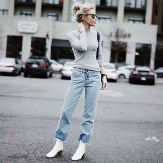 White Leather Ankle Boots Outfits: The formula for casual style? A grey crew-neck sweater with light blue fringe jeans. Feeling experimental? Jazz up this ensemble with a pair of white leather ankle boots.