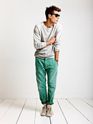 Mint Jeans Outfits For Men: This off-duty combination of a grey crew-neck sweater and mint jeans takes on different moods according to the way you style it. And if you want to immediately tone down your look with a pair of shoes, introduce beige high top sneakers to this outfit.
