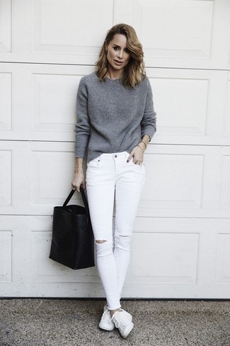 Black Leather Tote Bag Outfits: If you’re a jeans-and-a-tee kind of gal, you'll like this basic pairing of a grey crew-neck sweater and a black leather tote bag. To give your overall outfit a dressier vibe, complete your ensemble with a pair of white leather low top sneakers.