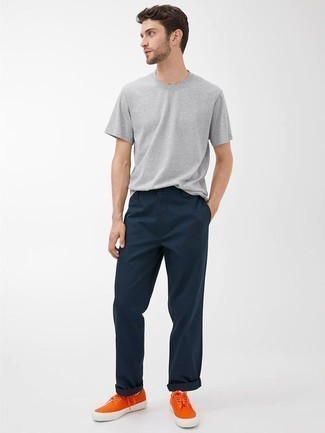 Orange Canvas Low Top Sneakers Outfits For Men: This casual pairing of a grey crew-neck t-shirt and navy chinos is a safe option when you need to look stylish in a flash. If you're not sure how to finish, a pair of orange canvas low top sneakers is a surefire option.