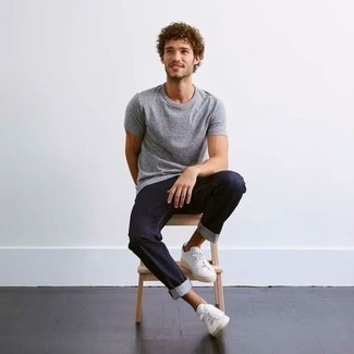 Navy Jeans Hot Weather Outfits For Men: Want to infuse your closet with some laid-back dapperness? Reach for a grey crew-neck t-shirt and navy jeans. Let your outfit coordination chops truly shine by rounding off your outfit with a pair of white canvas low top sneakers.