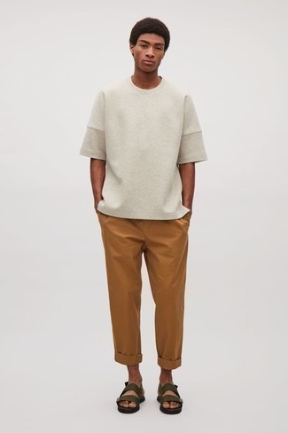 Olive Sandals Outfits For Men: This pairing of a grey crew-neck t-shirt and tobacco chinos is an exciting idea for when it's time to clock off. For something more on the casual and cool side to complement this ensemble, complete this outfit with a pair of olive sandals.