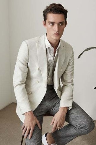 Grey Double Breasted Blazer Outfits For Men: This refined combo of a grey double breasted blazer and grey dress pants is a must-try look for today's man. Add white and black leather low top sneakers to the mix to effortlessly turn up the fashion factor of your look.