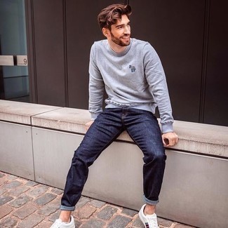 Charcoal Sweatshirt Outfits For Men: A charcoal sweatshirt and navy jeans married together are a perfect match. When it comes to shoes, complete your ensemble with white print canvas low top sneakers.