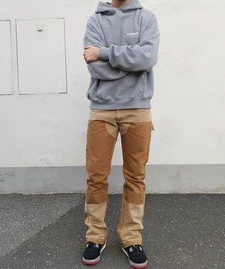 Khaki Jeans Outfits For Men: A grey hoodie and khaki jeans are absolute menswear must-haves that will integrate nicely within your daily off-duty repertoire. Now all you need is a great pair of black suede low top sneakers to finish off this look.
