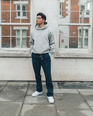 Grey Hoodie Outfits For Men: You'll be amazed at how easy it is for any man to get dressed like this. Just a grey hoodie and navy chinos. The whole look comes together if you finish off with white canvas low top sneakers.