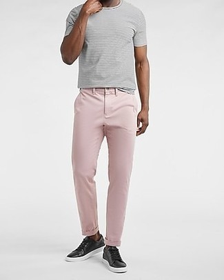 Black Leather Low Top Sneakers Outfits For Men: Super dapper and practical, this laid-back pairing of a grey horizontal striped crew-neck t-shirt and pink chinos offers variety. The whole outfit comes together when you introduce a pair of black leather low top sneakers to the equation.