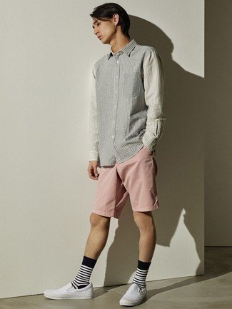 White Canvas Slip-on Sneakers Outfits For Men: The versatility of a grey vertical striped long sleeve shirt and pink shorts ensures they'll be on heavy rotation in your closet. A good pair of white canvas slip-on sneakers pulls this look together.