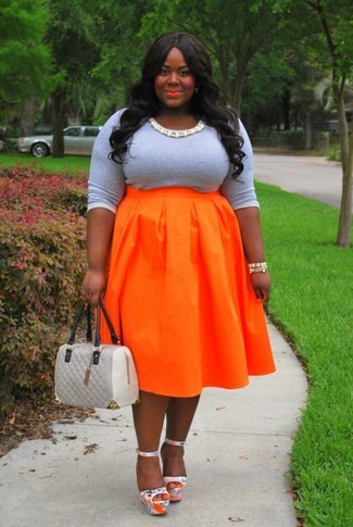 Grey Long Sleeve T-shirt Outfits For Women: This pairing of a grey long sleeve t-shirt and an orange full skirt is seriously stylish and yet it's casual and apt for anything. Up the ante of your getup by sporting a pair of silver leather heeled sandals.