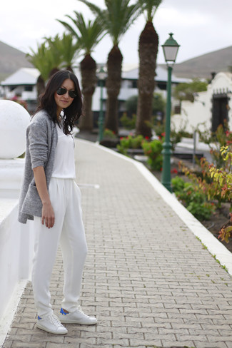 Open Cardigan Outfits For Women: Combining an open cardigan with a white jumpsuit is a wonderful choice for a casual yet totaly stylish ensemble. White low top sneakers round off this getup very well.