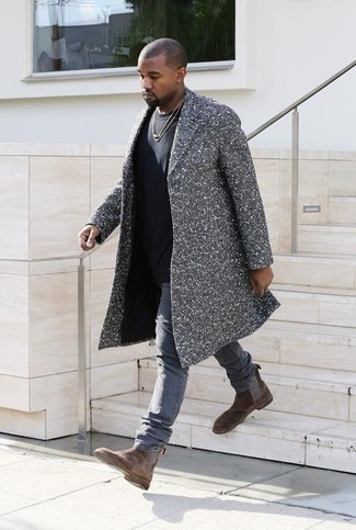 Kanye West wearing Grey Herringbone Overcoat, Black Crew-neck T-shirt, Grey Jeans, Brown Suede Chelsea Boots