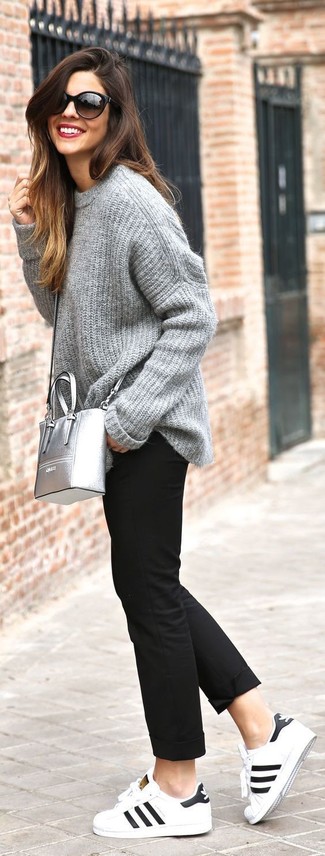 White Leather Low Top Sneakers Outfits For Women: This combination of a grey knit oversized sweater and black chinos is super easy to imitate and so comfortable to wear a variation of from dawn till dusk as well! A pair of white leather low top sneakers finishes this ensemble very well.