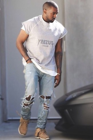 Kanye West wearing Grey Print Crew-neck T-shirt, Light Blue Ripped Jeans, Tan Athletic Shoes