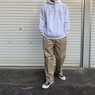 Navy and White Canvas Low Top Sneakers Outfits For Men: Fashionable and functional, this casual pairing of a grey print hoodie and khaki chinos will provide you with variety. Complement your look with a pair of navy and white canvas low top sneakers and the whole look will come together.