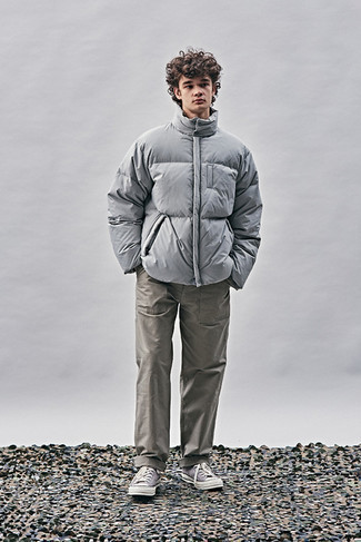 Men's Outfits 2022: A grey puffer jacket and grey chinos matched together are the perfect getup for those who appreciate effortlessly smart getups. To introduce a mellow touch to your ensemble, throw a pair of light violet canvas high top sneakers into the mix.