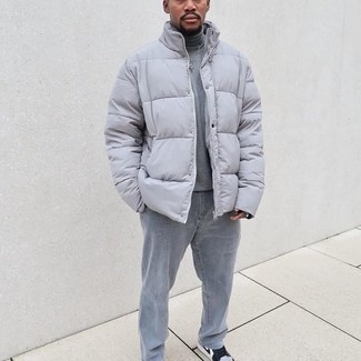Grey Puffer Jacket Outfits For Men: A grey puffer jacket and grey jeans are an easy way to introduce extra sophistication into your casual lineup. Kick up your whole ensemble by slipping into a pair of white and black leather low top sneakers.