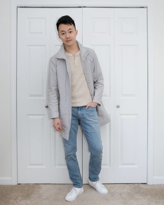 Grey Raincoat Outfits For Men: This casual combo of a grey raincoat and light blue jeans is perfect if you need to go about your day with confidence in your look. White canvas low top sneakers will be a stylish addition to your ensemble.