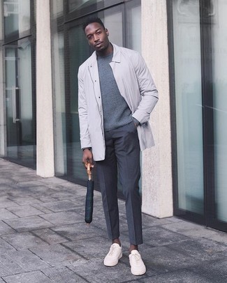 Grey Raincoat Outfits For Men: A grey raincoat and charcoal dress pants? This look will make ladies go weak in the knees. Beige canvas low top sneakers will bring a mellow feel to an otherwise dressy ensemble.
