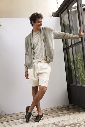 White Shorts Outfits For Men: This pairing of a grey shawl cardigan and white shorts is simple, sharp and very easy to recreate. Consider black leather boat shoes as the glue that will bring your look together.