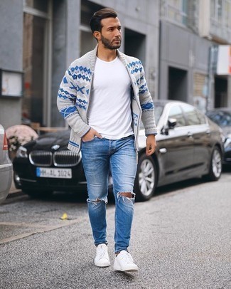 Navy Ripped Jeans Outfits For Men: A grey fair isle shawl cardigan and navy ripped jeans are amazing menswear must-haves that will integrate nicely within your casual lineup. A pair of white canvas low top sneakers easily boosts the wow factor of this ensemble.