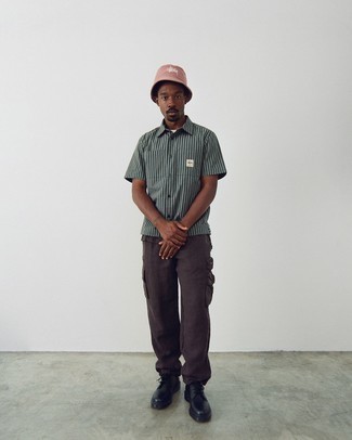 Pink Bucket Hat Outfits For Men: Putting together a grey vertical striped short sleeve shirt with a pink bucket hat is an on-point idea for a cool and relaxed outfit. Finishing with a pair of black chunky leather derby shoes is a simple way to add a bit of fanciness to your outfit.