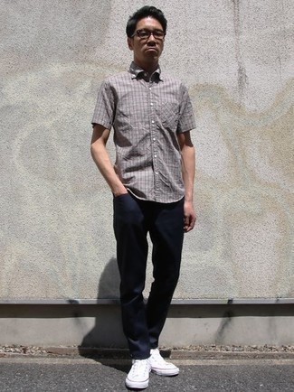 Charcoal Check Short Sleeve Shirt Outfits For Men: For an ensemble that's super easy but can be flaunted in a ton of different ways, team a charcoal check short sleeve shirt with navy chinos. A pair of white canvas low top sneakers is a wonderful pick to round off this outfit.