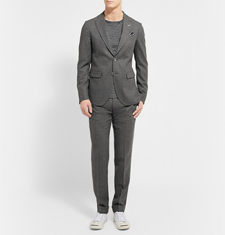 Charcoal Wool Suit Outfits: Pair a charcoal wool suit with a black and white horizontal striped crew-neck t-shirt and you'll assemble a proper and sophisticated look. Change up your look by rocking white low top sneakers.