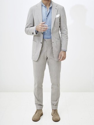 Grey Vertical Striped Suit Outfits: Go for a simple but polished ensemble in a grey vertical striped suit and a light blue long sleeve shirt. For a more casual twist, complement this outfit with beige suede desert boots.