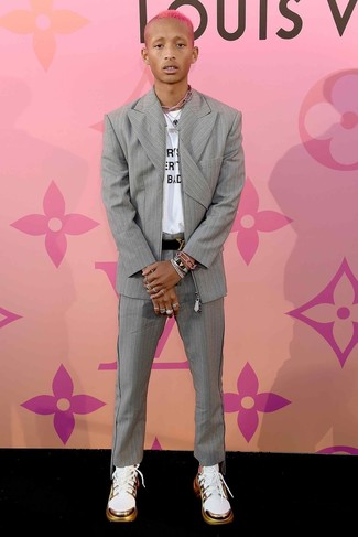 Jaden Smith wearing Grey Vertical Striped Suit, White and Black Print Crew-neck T-shirt, White Athletic Shoes, Black Leather Belt
