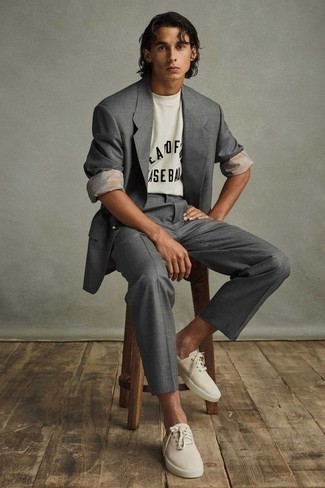 Beige Suede Low Top Sneakers Outfits For Men: A grey suit and a white and black print crew-neck t-shirt combined together are a match made in heaven. Let your styling sensibilities really shine by finishing your outfit with a pair of beige suede low top sneakers.
