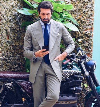 Blue Tie Outfits For Men: Putting together a grey suit and a blue tie is a surefire way to inject your current repertoire with some rugged sophistication.