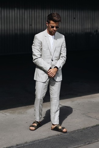 Grey Suit Hot Weather Outfits: Go effortlessly smart in a grey suit and a white crew-neck t-shirt. Balance this ensemble with more relaxed footwear, such as this pair of dark green leather sandals.