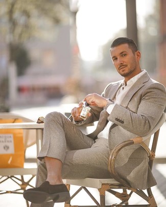 A grey wool suit looks so elegant when married with a white dress shirt for a look worthy of a contemporary gentleman. Add a pair of black suede loafers to the mix to make a dressy look feel suddenly fun and fresh.