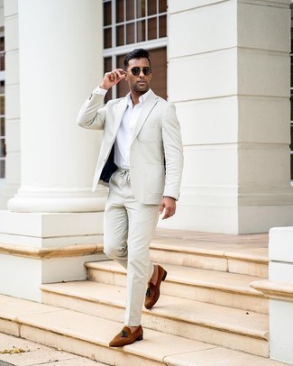 Grey Suit Outfits: Marry a grey suit with a white dress shirt if you're going for a neat, stylish ensemble. To infuse a carefree feel into this ensemble, introduce brown suede tassel loafers to the equation.