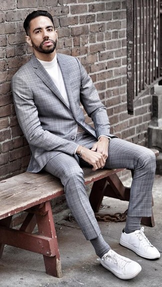 Grey Plaid Suit Outfits: Try pairing a grey plaid suit with a white turtleneck and you'll assemble a proper and sophisticated ensemble. For a more casual twist, complement your outfit with a pair of white canvas low top sneakers.