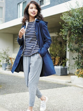 Women's White Leather Low Top Sneakers, Grey Sweatpants, Navy and White Horizontal Striped Long Sleeve T-shirt, Navy Raincoat
