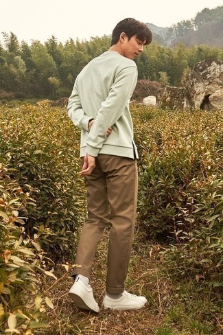 Brown Chinos Outfits: Rock a grey sweatshirt with brown chinos to achieve a day-to-day outfit that's full of style and character. Finish off with white canvas low top sneakers and the whole getup will come together brilliantly.