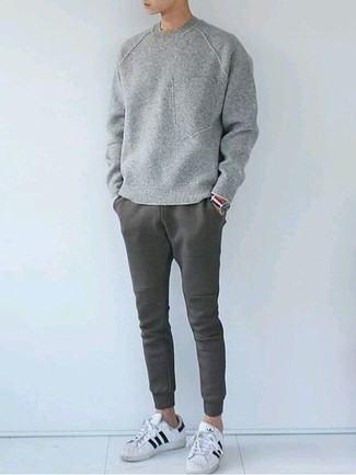 Grey Sweatpants Outfits For Men: For something on the relaxed side, try teaming a grey sweatshirt with grey sweatpants. Consider a pair of white and black leather low top sneakers as the glue that ties your ensemble together.