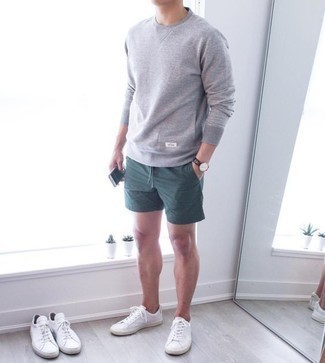 Dark Green Shorts Outfits For Men: A grey sweatshirt and dark green shorts are great menswear essentials that will integrate brilliantly within your current rotation. On the footwear front, this look pairs nicely with white canvas low top sneakers.