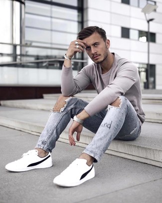 White Leather Low Top Sneakers Relaxed Outfits For Men: This combination of a grey sweatshirt and light blue ripped jeans is proof that a simple casual ensemble doesn't have to be boring. Feeling inventive? Shake up your ensemble by finishing with a pair of white leather low top sneakers.