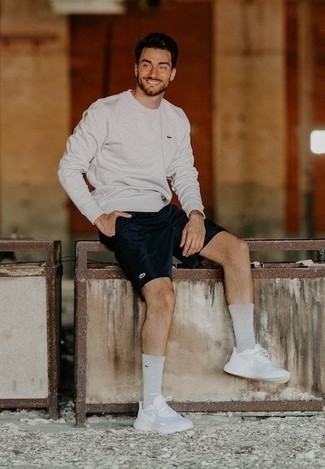 Charcoal Sweatshirt Outfits For Men: Wear a charcoal sweatshirt with navy shorts for a no-nonsense menswear style that's also put together nicely. Kick up this whole ensemble by rounding off with white athletic shoes.