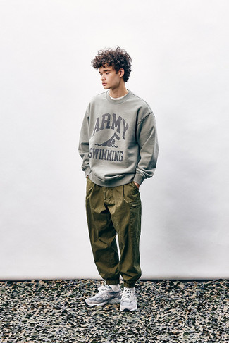Men's Outfits 2022: If you appreciate comfortable style, consider wearing a grey print sweatshirt and olive cargo pants. To bring an air of stylish casualness to your getup, add a pair of grey athletic shoes to the mix.