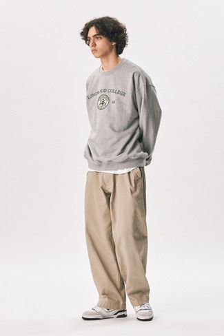 Grey Print Sweatshirt Outfits For Men: Reach for a grey print sweatshirt and khaki chinos if you wish to look casually dapper without spending too much time. White and black leather low top sneakers look perfectly at home here.