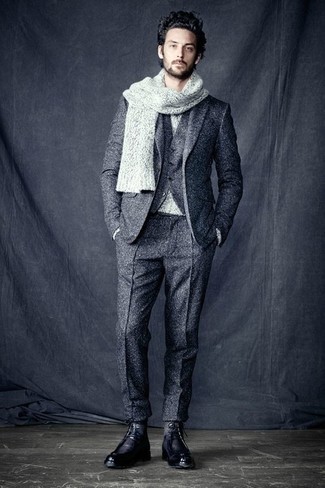 Grey Knit Scarf Outfits For Men: A grey wool three piece suit and a grey knit scarf are a smart pairing worth incorporating into your casual collection. Puzzled as to how to finish this outfit? Rock a pair of black leather casual boots to lift it up.