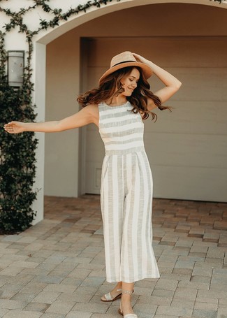 Silver Flat Sandals Outfits: Stylish yet comfy, this outfit features a grey vertical striped jumpsuit. For a more relaxed touch, introduce silver flat sandals to this getup.