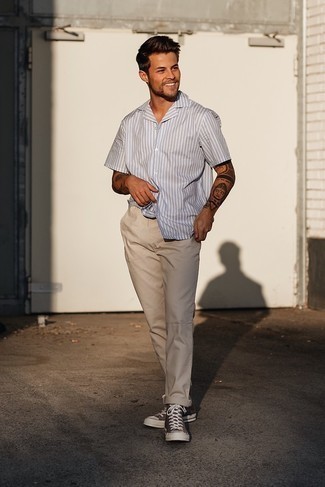 Dark Brown Canvas High Top Sneakers Outfits For Men: Consider teaming a grey vertical striped short sleeve shirt with beige chinos for a sharp, relaxed casual getup. Feeling venturesome today? Switch things up by sporting a pair of dark brown canvas high top sneakers.